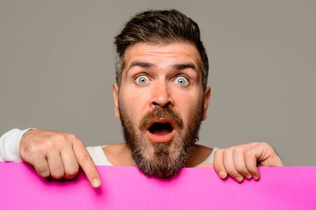 Surprised man holding advertising board. Advertising and sale. Online shopping. Advertising banner....