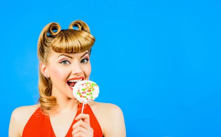 Lollipop. Sweet food. Sweets. Dessert. Woman eating lollipop. Pin up model with lollipop in hand....