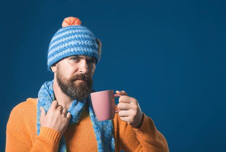 Taking coffee break. Handsome bearded man holds cup of coffee. Serious man with beard&mustache hold cup or mug tea. Drinking coffee concept. Stylish man drinks cup of coffee/cappuccino. Copy space.の写真素材