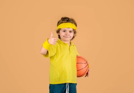 Active sports lifestyle. Basketball game concept. Cute boy playing basketball.の写真素材