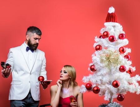 Couple before New year at romantic dinner in restaurant. Couple in love at Christmas or New year. Romantic relationships. New Year's Eve. Christmas tree. Family, presents, surprise, winter, happiness.の写真素材
