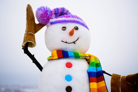 Handmade snowman in hat&scarf. New Year attribute. Christmas decoration. Cute snowman in knitted hat&striped scarf.の写真素材