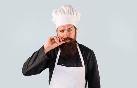 Professional chef man. Chief man in uniform. Male chef, cook or baker in white uniform. Bearded chef in cook hat. Man cook in chef hat and uniform. Cooking, food, profession and inspiration conceptの写真素材