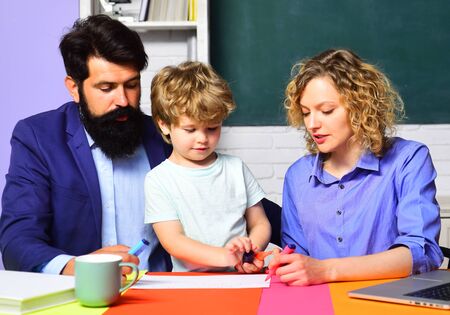 Home family schooling. Parents teaching kids private lessons in math. Back to school. Home...