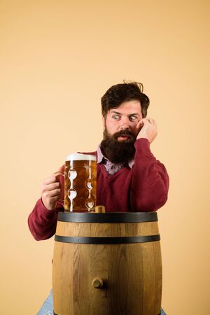 Alcohol. Beer. Wooden barrel. Glass of beer. Oktoberfest. Excited bearded man with glass of beer.We meet oktoberfest. Drinking beer. Germany traditionsの写真素材