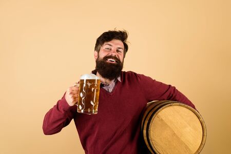 Brewer. Handsome bearded man drinking beer. Equipment for preparation of beer. Brewery concept. Man...