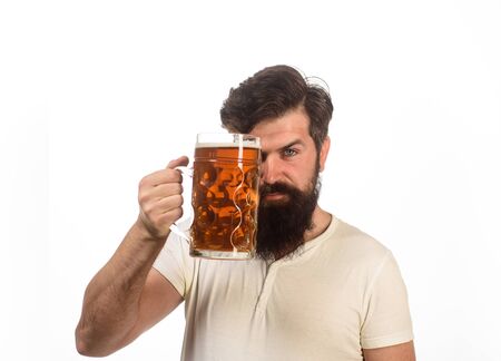 Beer pub. Stylish handsome man drinking beer of glass on party. Smiling bearded hipster drinking craft beer from mug. Brewing. Stylish guy at cafe pub. Beer time. Alcohol, harmful habits. Oktoberfestの写真素材