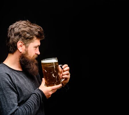 Bearded man holds beer glass. Celebration oktoberfest festival. Lager and dark ale. Handsome man...