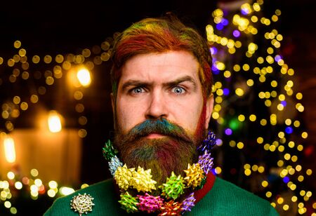 Christmas Santa. Christmas Beard style. Delivery gifts. New year gift. Expression and people concept - man with funny face over Christmas background. Christmas decorationsの写真素材