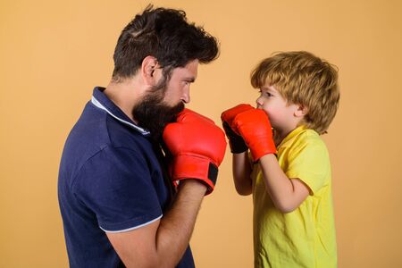 Boy boxing training punch exercise concept. Father and son during boxing training. Cute little boy...