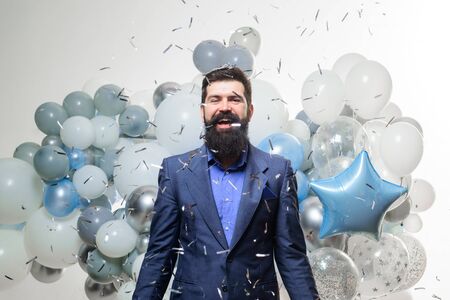 Celebration, holidays, party concept. Happy businessman with flying confetti. Party man with air...