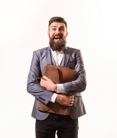 Fashionable man dressed in formal suit with briefcase. Elegant businessman in suit with briefcase. Businessman holds fashion men's leather briefcase. Business man in suit hold briefcase for documentsの写真素材