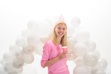 Balloon. Party mood. Beautiful girl in birthday hat with balloons. Girl in pajama celebrate pajama party. Smiling woman in party balloons. Happy birthday celebration. Party celebration with balloonsの写真素材