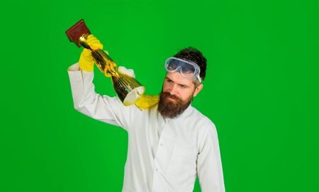 Cleaning, cleanliness, cleaning products. Domestic work. Man from professional cleaning service. Housework, housekeeping. Bearded man in uniform and gloves holds gold trophy cup. Victory over dirtの写真素材
