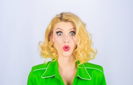 Beautiful surprised woman with clean skin. Perfect make-up. Pretty blond girl. Emotional woman has surprised facial expression. Amazed young woman. Beautiful young girl. People emotion and expressionの写真素材