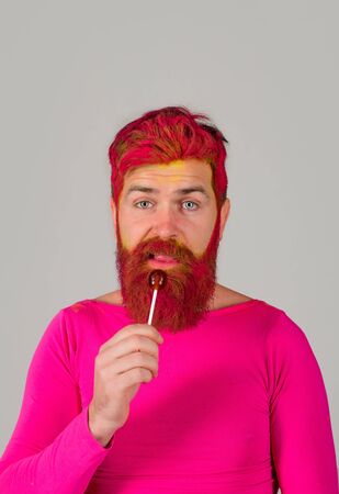 Lollipop. Dessert. Licking candy. Bearded man with lollipop. Man eat lollipop. Sweet. Sugar. Candy. Candy shop. Sweets. Sweet foodの写真素材