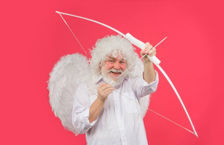 Valentines cupid. Angel man with white wings. Cupid with bow and arrows. Love concept. Valentine angel. Handsome male angel Cupid. Bearded man with angel wings. Valentines day card. Valentines Dayの写真素材