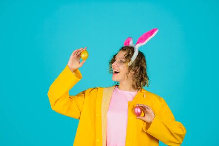 Eggs hunt. Happy Easter. Egg hunt. Woman with rabbit ears holds Easter egg. Woman in bunny ears...