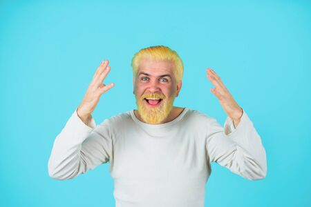 Barbershop. Surprised man with bleached hair. Man with bleached hair and beard. Coloring of men's...