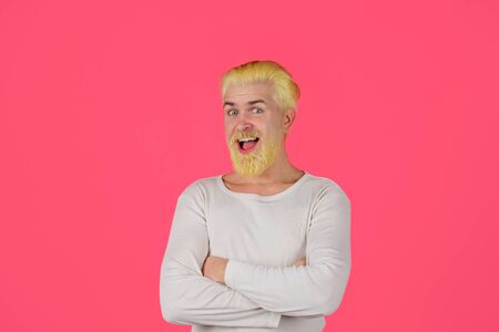 Barbershop. Eccentric man with dyed hair. Coloring of men's hair. Bearded man with dyed blonde hair. Handsome man with stylish haircut. Blonde hipster guy. Modern handsome man with blonde dyed hairの写真素材