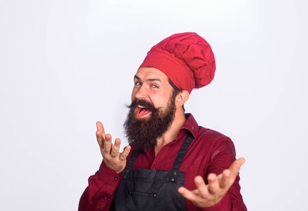 Happy cook in chef uniform. Professional chef man. Cooking, profession. Chef in kitchen. Chef. Cook. Baker in hat and apron. Cook and professional culinaryの写真素材