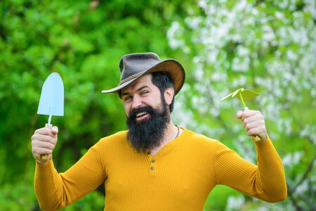 Work in garden. Bearded man with gardening tools. Gardener work. Farm. Work in garden. Spring. Smiling man preparing to planting. Plantsの写真素材