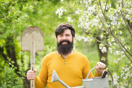 Work in garden. Bearded man with gardening tools. Garden work. Farm. Work in garden. Spring. Smiling man preparing to planting. Plantsの写真素材