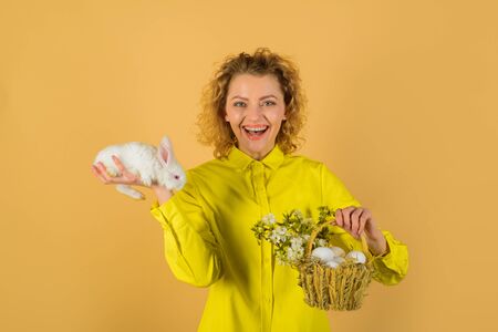 Basket with eggs. Eggs hunt. Easter egg. Bunny. Happy Easter day. Cute furry rabbit. Smiling woman...