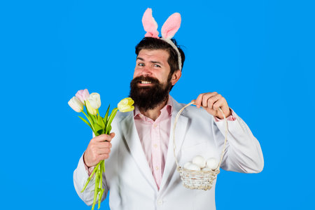 Easter. Egg hunt. Easter eggs. Smiling bearded man hold basket of egg. Happy Easter. Bearded man....
