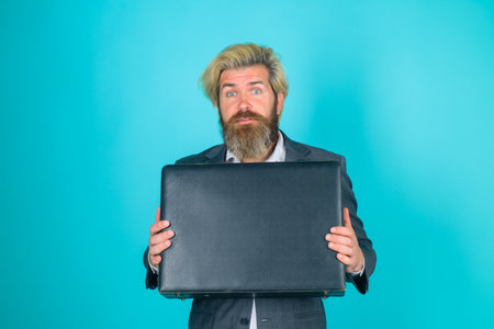 Businessman with suitcase. Business. Office worker. CEO. Smiling businessman in suit. Business, people and office concept. Bearded businessman with case. Isolatedの写真素材