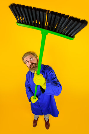 House cleaning. Broom. Bearded man with broom. Cleaning and disinfection toilet. Professional cleaning. Cleaning service. Clean up. Clearing tools. Household. Housekeeping. Besom.の写真素材