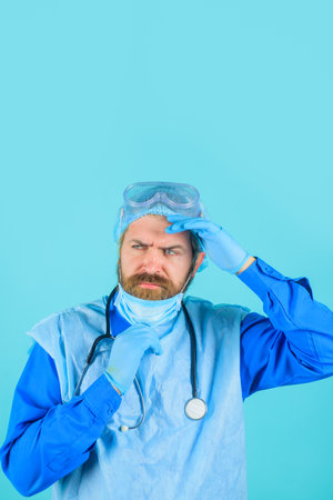 Doctor with stethoscope. Man doctor in protective suit and medical mask. Medical physician doctor man. Healthcare, profession and medicine concept. Handsome doctor in medical uniform with stethoscopeの写真素材
