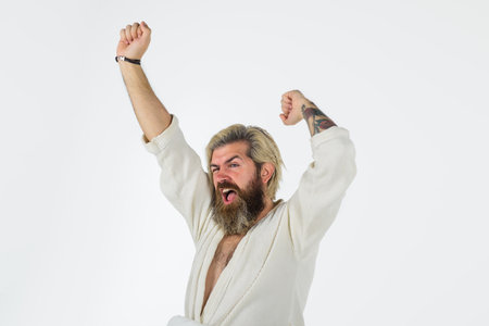 Sleepy man yawning. Tired sleepy man in bathrobe. Morning routine. Man in bedroom. Morning and wake...