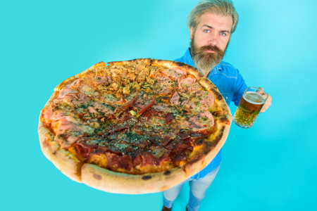 Pizza time. Fastfood. Bearded man holds pizza. Man eat fresh pizza. Delicious fast food meal. Italian cuisine concept. Tasty pizza at restaurant. Lunch or dinner.の写真素材