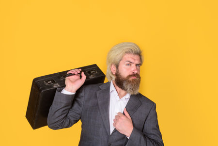 Serious businessman with suitcase. Business. Office worker. CEO. Bearded businessman in suit. Business, people and office concept. Bearded businessman with case. Business growthの写真素材