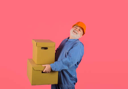 Delivery service, mail, shipment. Move in. Move out. Delivery man with parcel. Man holds cardboard box. Delivery from shop. Bearded man carry boxesの写真素材