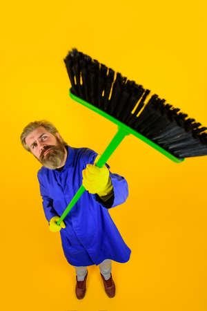 House cleaning. Broom. Bearded man with broom. Cleaning and disinfection. Professional cleaning. Cleaning service. Clean up. Clearing tools. Household. Housekeeping. Besomの写真素材