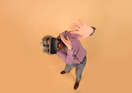 VR. Scared man in virtual reality headset. Future. Future technology concept. Men using VR headset....