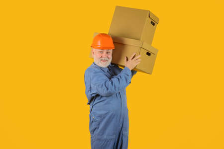 Delivery from shop. Bearded man carry boxes. Delivery service. Shipment. Delivery concept. Delivery man with boxes. Man holds cardboard boxの写真素材