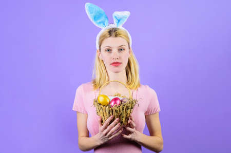Easter Day. Woman with basket eggs. Bunny girl. Egg hunt.