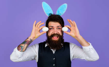 Happy Easter. Bunny man with white eggs. Egg hunt. male in bunny ears.の写真素材