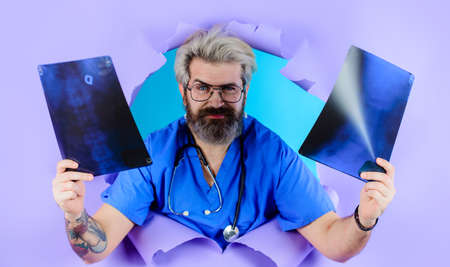 Healthcare, medical and radiology. Doctor with x-ray or roentgen image. Man with xray photo of spine. Radiograph.の写真素材