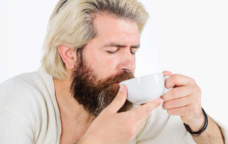 Good morning. Bearded man with cup of coffee. Handsome male enjoying mug of drink.の写真素材