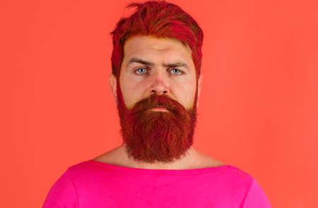 Barber shop. Hairstyle. Serious man with dyed beard and hair. Hipster with pink hair.の写真素材