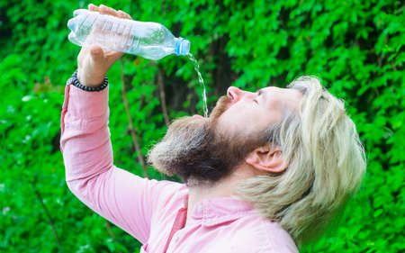 Hydration concept. Bearded man drinking water. Male with water bottle. Healthy lifestyle.の写真素材