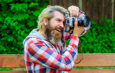 Photographer with modern digital camera. Bearded man with professional camera. Professional...