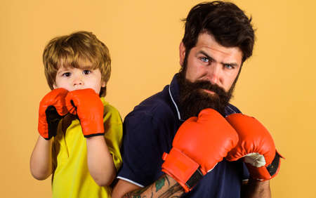 Father training his son boxing. Family workout. Sport lifestyle. Parenthood.の写真素材