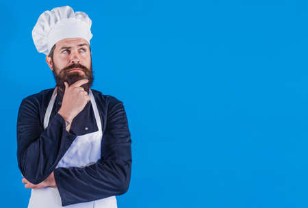 Serious bearded chef in uniform. Professional cook. Restaurant Kitchen. Cooking. Advertising.の写真素材