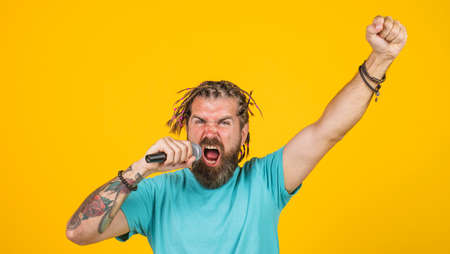Bearded Man singing karaoke. Studio records. Attractive singer sing with microphone.
