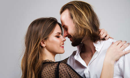 Portrait of smiling couple. Love. Sensuality. Happy cute lovers embracing.